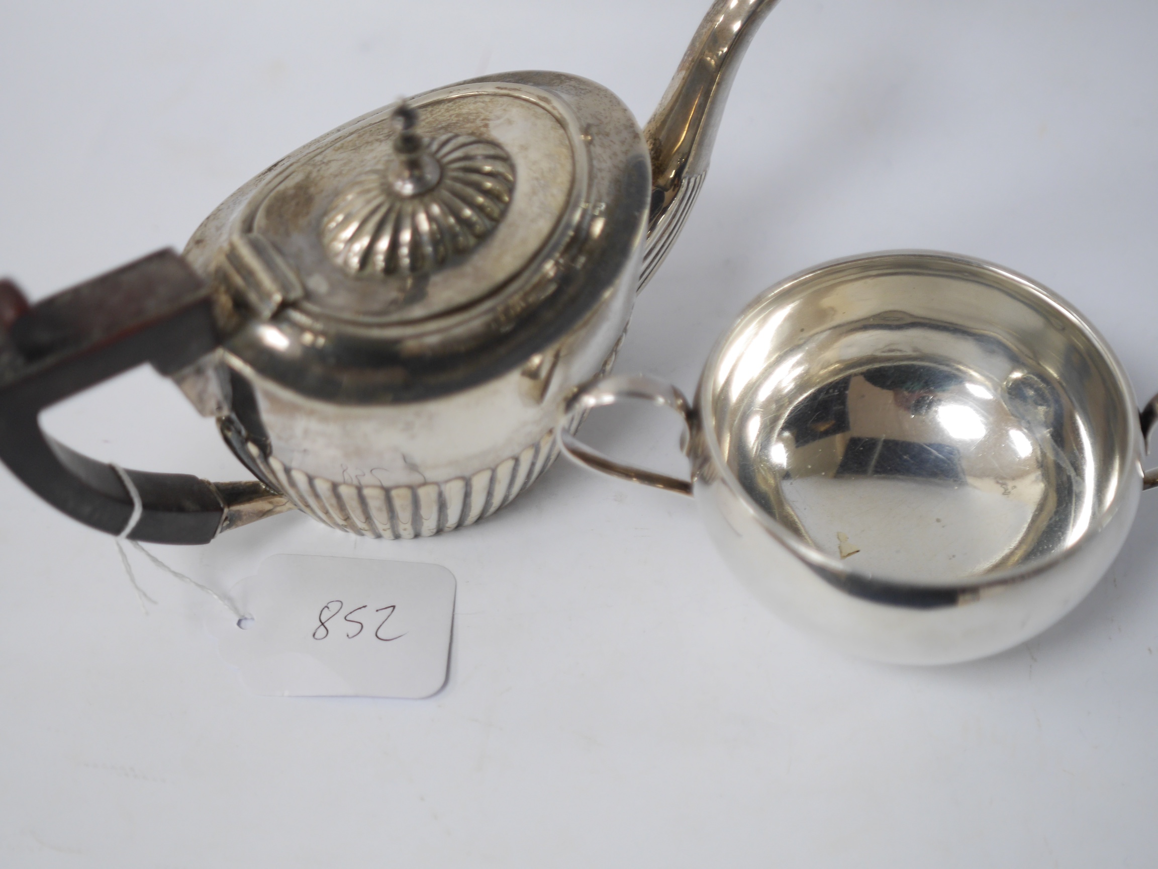 A late 19th/early 20th century continental white metal chatelaine, hung with six assorted accoutrements including a small silver box, a George III silver oval snuff box, a pen knife, compass and cross pendant. overall ap